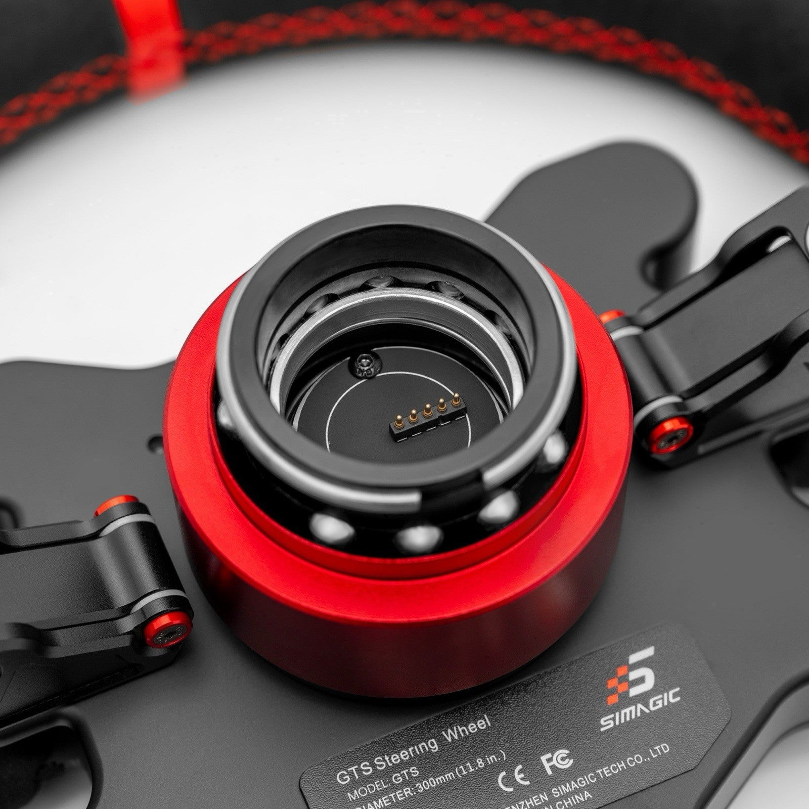 Simagic GTS Alcantara wheel rear view showing quick-release hub and Simagic wiring connector